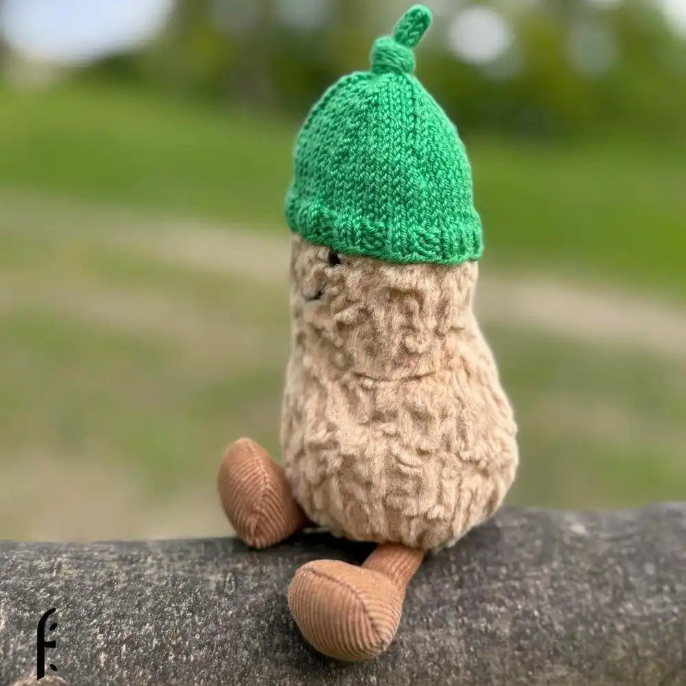 Plush peanut with green knit cap.